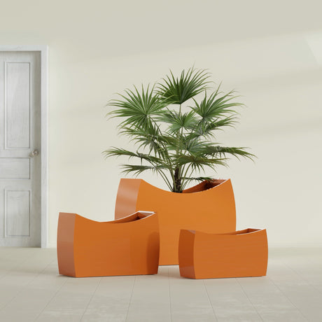 Seoul Curved fiberglass planter in Gloss Tangerine, size range, in a sunlit interior