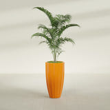 San Jose Tall Fluted fiberglass planter in Gloss Tangerine, planted, in a sunlit interior