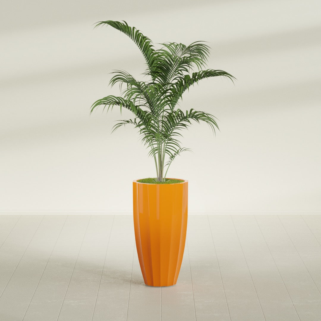 San Jose Tall Fluted fiberglass planter in Gloss Tangerine, planted, in a sunlit interior