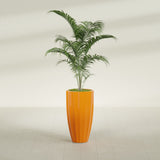 San Jose Tall Fluted fiberglass planter in Gloss Tangerine, planted, in a sunlit interior