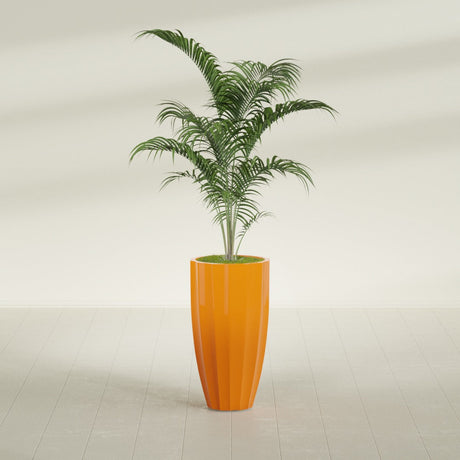 San Jose Tall Fluted fiberglass planter in Gloss Tangerine, planted, in a sunlit interior