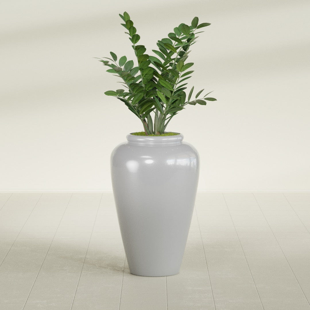 Barà Jar fiberglass planter in Metallic Silver, shown planted, in a sunlit interior