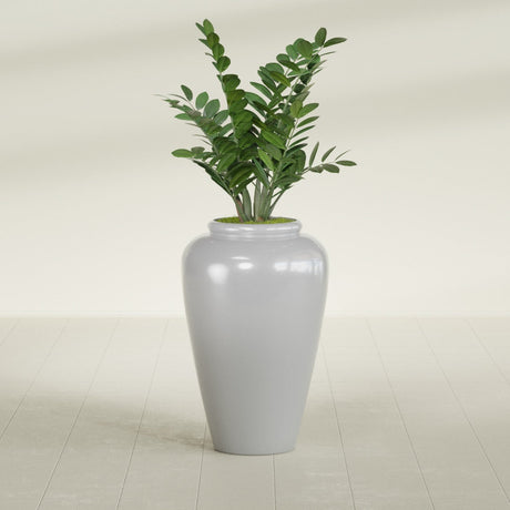 Barà Jar fiberglass planter in Metallic Silver, shown planted, in a sunlit interior