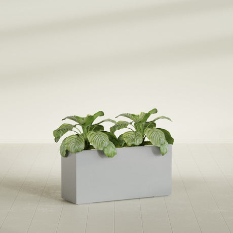 Miami Corner fiberglass planter in Metallic Silver, shown planted, in a sunlit interior