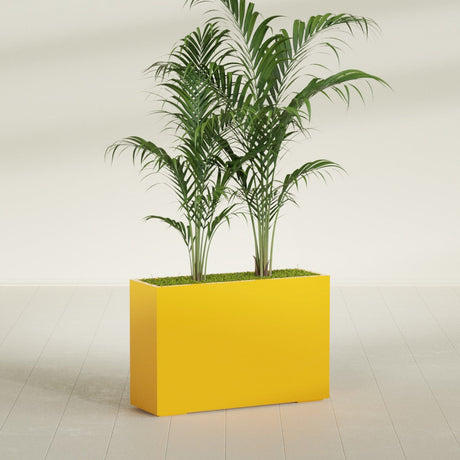 Potsdam Corner fiberglass planter in Gloss Saffron, shown planted, in a sunlit interior