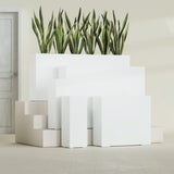Delray Corner fiberglass planter in Gloss Bright White, size range, in a sunlit interior