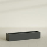 Cuba Low Rectangular Planter in Matte Charcoal, 60"L × 14"D × 12"H, shown empty
