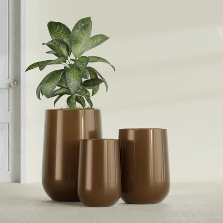 Hayden Urn fiberglass planter in Metallic Bronze, size range, in a sunlit interior