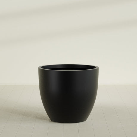 Wannsee Round Planter in Matte Black, 50"D × 44"H, shown empty
