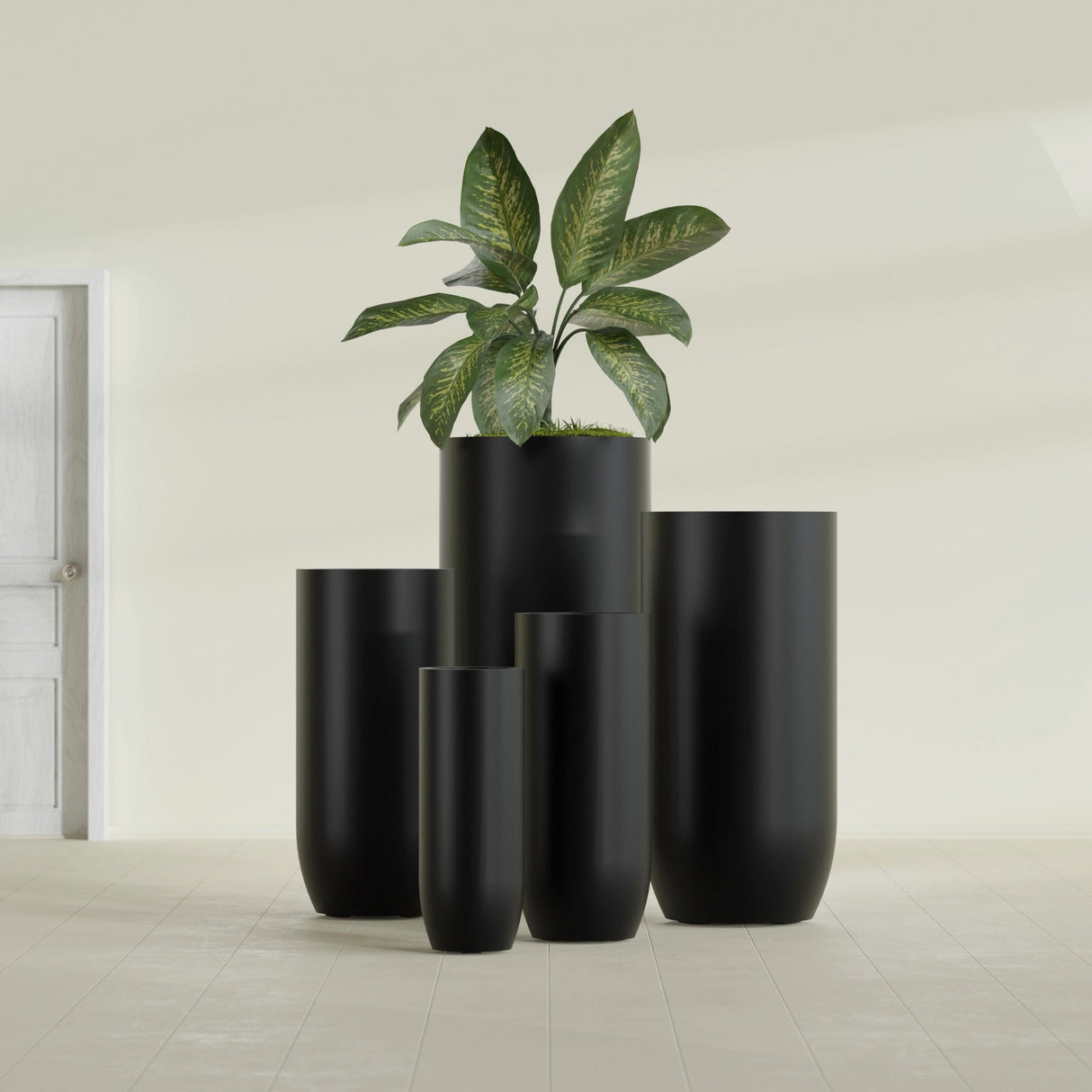 Saint Tropez Bullet Round fiberglass planter in Matte Black, size range, in a sunlit interior
