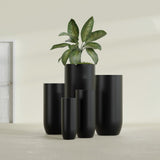 Saint Tropez Bullet Round fiberglass planter in Matte Black, size range, in a sunlit interior