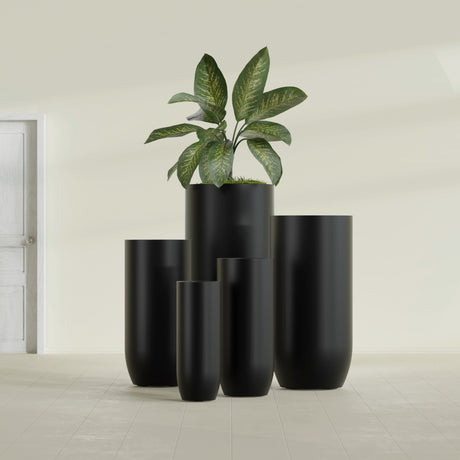 Saint Tropez Bullet Round fiberglass planter in Matte Black, size range, in a sunlit interior