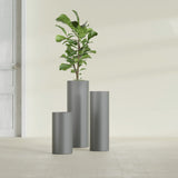 Corry Cylinder fiberglass planter in Matte Gunmetal, size range, in a sunlit interior