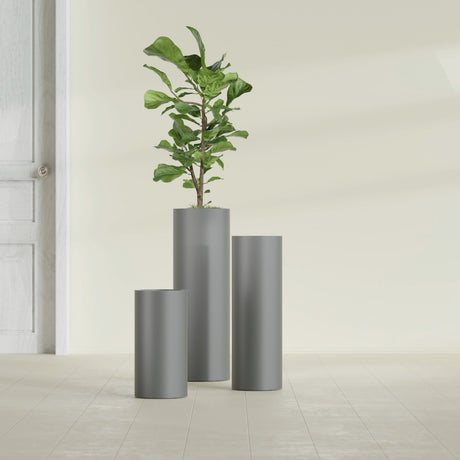 Corry Cylinder fiberglass planter in Matte Gunmetal, size range, in a sunlit interior