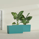 Panama Tapered Rectangular fiberglass planter in Satin Seafoam Green, shown planted, in a sunlit interior