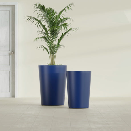 Tegel Round Tapered fiberglass planter in Matte Cobalt Blue, size range, in a sunlit interior