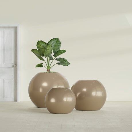 Globe fiberglass planter in Gloss Metallic Gold, size range, in a sunlit interior