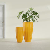 San Jose Tall Fluted fiberglass planter in Gloss Saffron, size range, in a sunlit interior