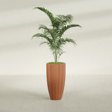 San Jose Tall Fluted fiberglass planter in Matte Terra Cotta, shown planted, in a sunlit interior