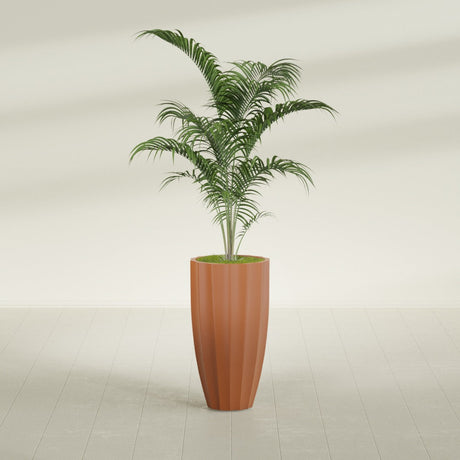 San Jose Tall Fluted fiberglass planter in Matte Terra Cotta, shown planted, in a sunlit interior