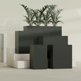 Darwin Corner fiberglass planter in Matte Charcoal, size range, in a sunlit interior