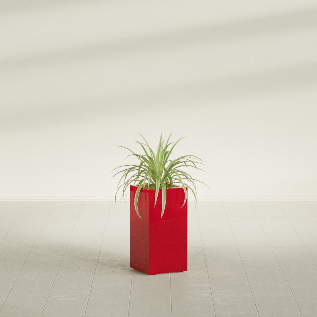 Hollywood Corner fiberglass planter in Gloss Red, shown planted, in a sunlit interior
