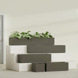 Cuba Low Rectangular fiberglass planter in Matte Bronze, size range, in a sunlit interior
