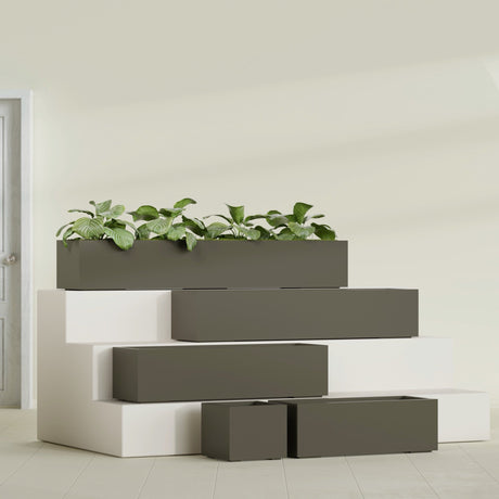 Cuba Corner fiberglass planter in Matte Bronze, size range, in a sunlit interior