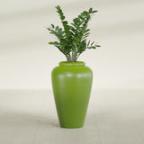 Barà Jar fiberglass planter in Satin Green, shown planted, in a sunlit interior