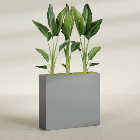 Amesbury Narrow Rectangular fiberglass planter in Matte Gunmetal, shown planted, in a sunlit interior