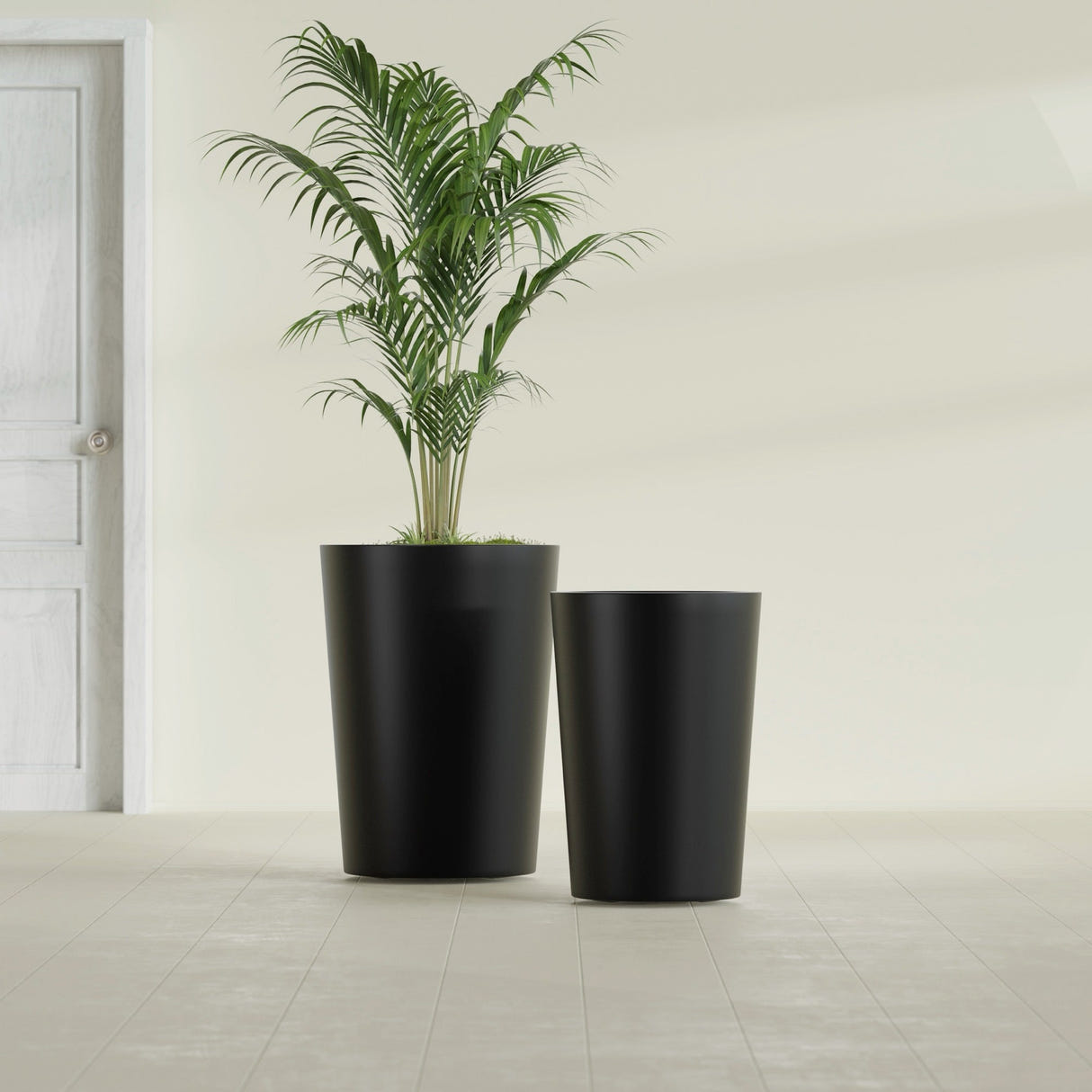 Tegel Round Tapered fiberglass planter in Matte Black, size range, in a sunlit interior