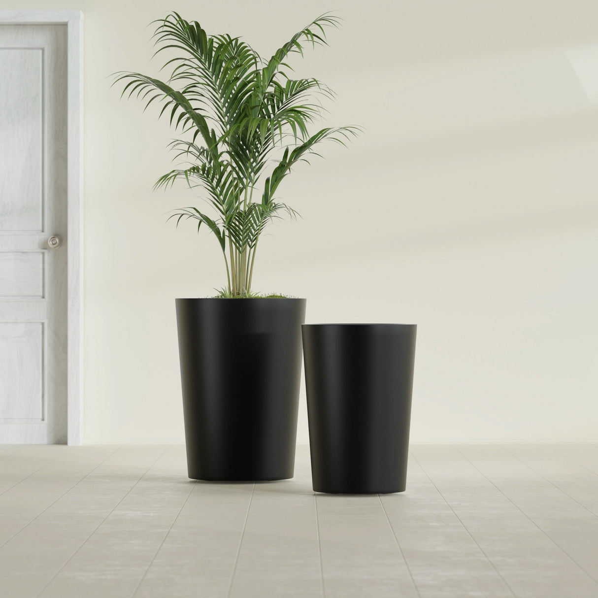 Tegel Round Tapered fiberglass planter in Matte Black, size range, in a sunlit interior