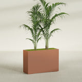 Potsdam Corner fiberglass planter in Matte Terra Cotta, shown planted, in a sunlit interior