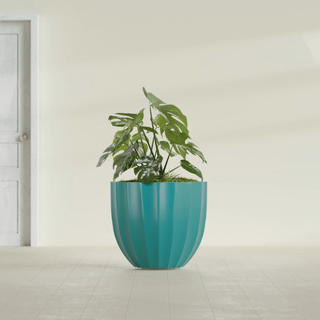 Santa Barbara Fluted Round fiberglass planter in Satin Seafoam Green, shown planted, in a sunlit interior