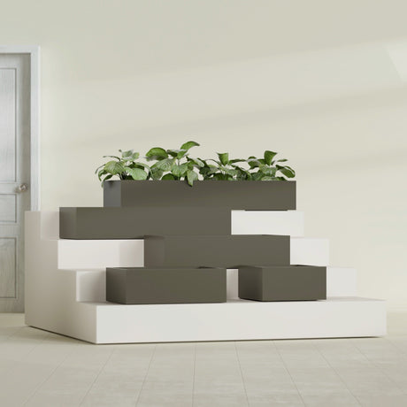 Antwerp Corner fiberglass planter in Matte Bronze, size range, in a sunlit interior