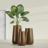 Saigon Tapered Round fiberglass planter in Metallic Bronze, size range, in a sunlit interior