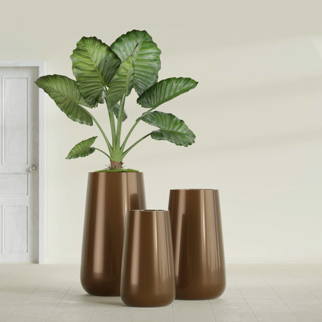 Saigon Tapered Round fiberglass planter in Metallic Bronze, size range, in a sunlit interior