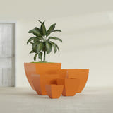 Lima Tapered Square fiberglass planter in Gloss Tangerine, size range, in a sunlit interior