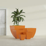 Lima Tapered Square fiberglass planter in Gloss Tangerine, size range, in a sunlit interior