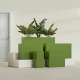 Potsdam Corner fiberglass planter in Satin Green, size range, in a sunlit interior