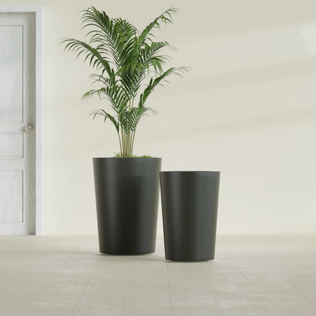 Tegel Round Tapered fiberglass planter in Matte Charcoal, size range, in a sunlit interior