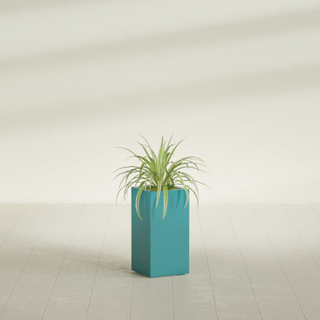 Hollywood Corner fiberglass planter in Satin Seafoam Green, shown planted, in a sunlit interior