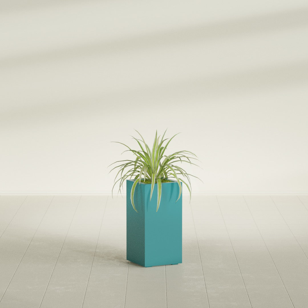 Hollywood Narrow Rectangular fiberglass planter in Satin Seafoam Green, shown planted, in a sunlit interior