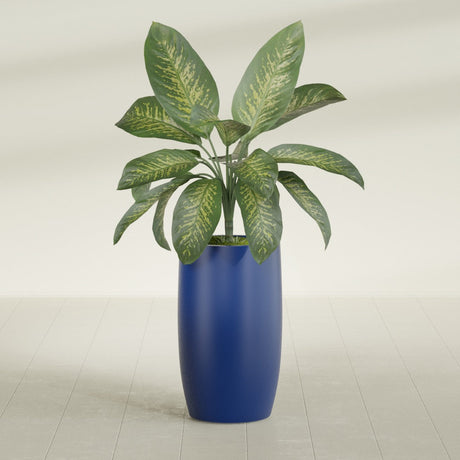 Lisbon tall round tapered fiberglass planter in Matte Cobalt Blue, planted, in a sunlit interior
