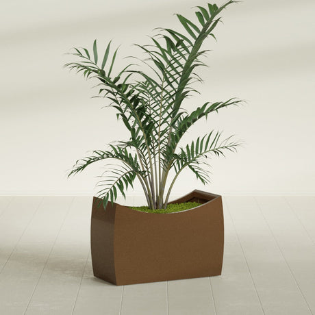 Seoul Curved fiberglass planter in Metallic Bronze, shown planted, in a sunlit interior