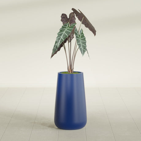 Saigon Tapered Round fiberglass planter in Matte Cobalt Blue, shown planted, in a sunlit interior