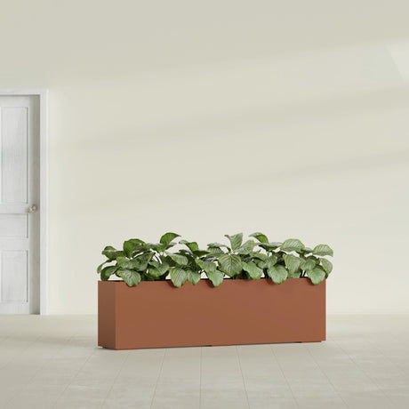 Hudson Extra Long fiberglass planter in Matte Terra Cotta, shown planted, in a sunlit interior