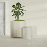 Rio Grande Cylinder fiberglass planter in Satin Beige, size range, in a sunlit interior