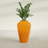 Barà Jar fiberglass planter in Gloss Tangerine, shown planted, in a sunlit interior