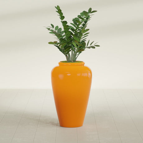 Barà Jar fiberglass planter in Gloss Tangerine, shown planted, in a sunlit interior